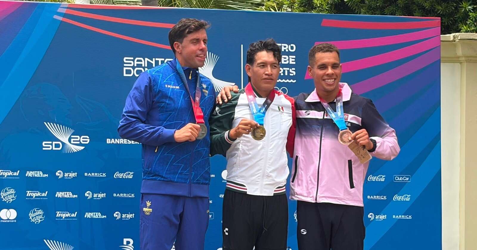 Tyler Smith on the CAC Games triathlon podium with his bronze medal